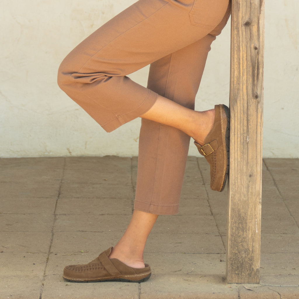 Model wearing Earth Shoes Eileen suede clogs in brown