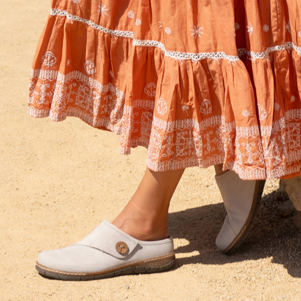 Model wearing Earth Shoes Ezra clogs in grey