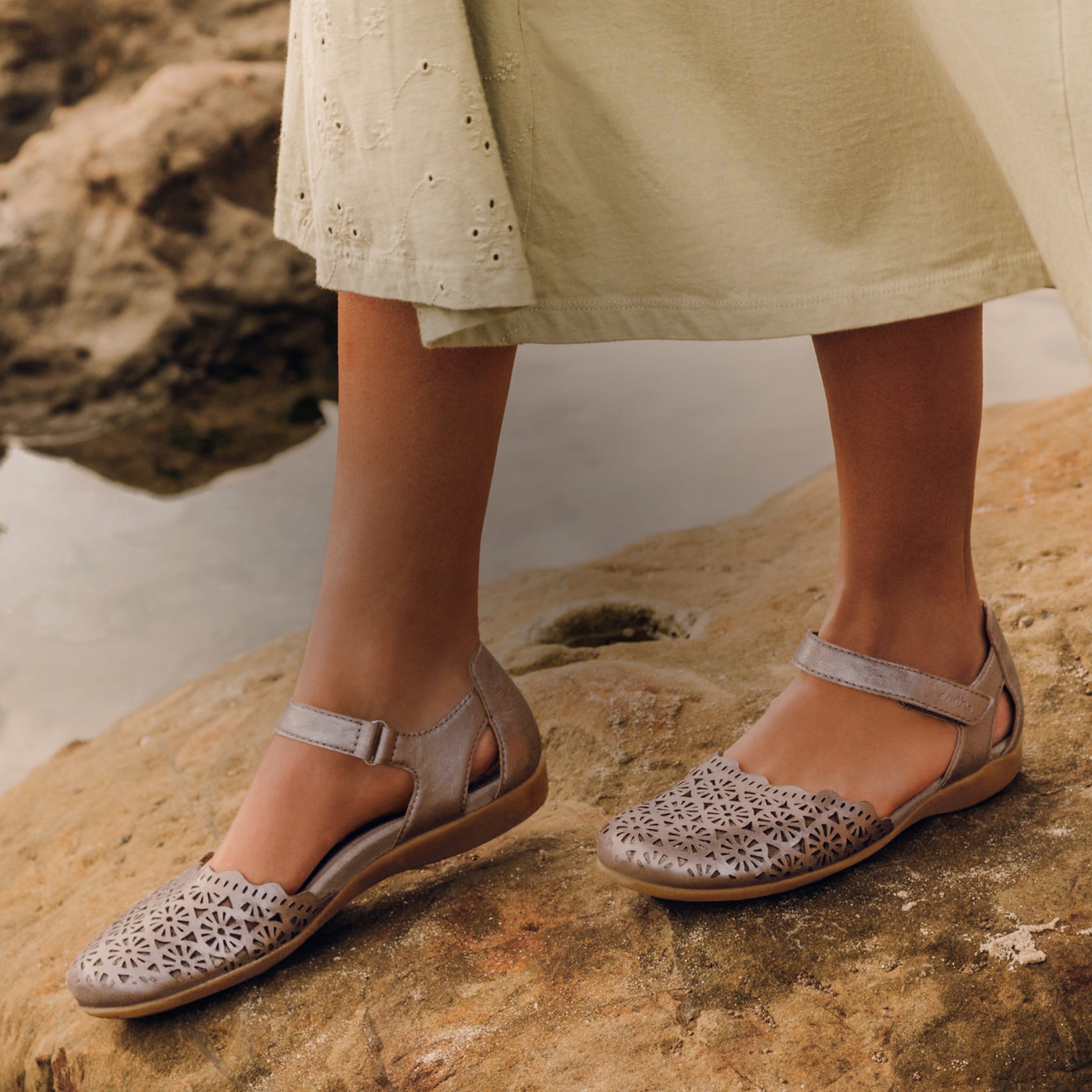 Model wearing Earth Shoes woven flat sandals in tan